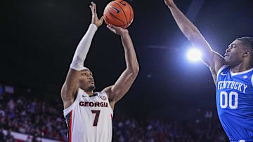 Jan 7, 2025; Athens, Georgia, USA; Georgia Bulldogs guard Tyrin Lawrence (7) shoots over Kentucky Wildcats guard Otega Oweh (00)  during the first half at Stegeman Coliseum. Mandatory Credit: Dale Zanine-Imagn Images