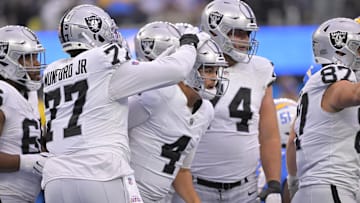 Oct 1, 2023; Inglewood, California, USA; Las Vegas Raiders quarterback Aidan O'Connell (4) is congratulated by offensive tackle Thayer Munford Jr. (77) after a touchdown in the first half against the Los Angeles Chargers at SoFi Stadium. Mandatory Credit: Jayne Kamin-Oncea-Imagn Images