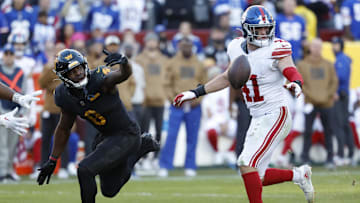Nov 19, 2023; Landover, Maryland, USA; Washington Commanders running back Brian Robinson Jr. (8) attempts to catch a pass as New York Giants linebacker Micah McFadden (41) defends during the fourth quarter at FedExField. Mandatory Credit: Geoff Burke-Imagn Images