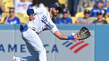 Oct 2, 2022; Los Angeles, California, USA;  Los Angeles Dodgers right fielder Joey Gallo (12) misses a triple by Colorado Rockies right fielder Randal Grichuk (15) in the ninth inning at Dodger Stadium. Mandatory Credit: Jayne Kamin-Oncea-Imagn Images