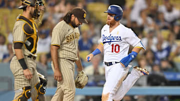 Sep 2, 2022; Los Angeles, California, USA;  San Diego Padres relief pitcher Nabil Crismatt (74) looks on as Los Angeles Dodgers third baseman Justin Turner (10) crosses the plate for a run in the ninth inning at Dodger Stadium. Mandatory Credit: Jayne Kamin-Oncea-Imagn Images