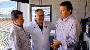 Oct 5, 2022; Los Angeles, California, USA; Retiring Spanish-language broadcaster Jaime Jarrin (center) talks with Pepe Yniguez (left) and Fernando Valenzuela (right) prior to the game against the Colorado Rockies at Dodger Stadium. Valenzuela and Yniguez will be the Spanish broadcast team for SportsNet LA.