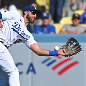 Oct 2, 2022; Los Angeles, California, USA;  Los Angeles Dodgers right fielder Joey Gallo (12) misses a triple by Colorado Rockies right fielder Randal Grichuk (15) in the ninth inning at Dodger Stadium. Mandatory Credit: Jayne Kamin-Oncea-Imagn Images
