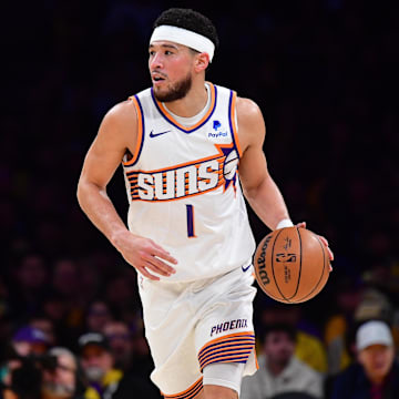 Jan 11, 2024; Los Angeles, California, USA; Phoenix Suns guard Devin Booker (1) moves the ball up court against the Los Angeles Lakers during the first half at Crypto.com Arena. Mandatory Credit: Gary A. Vasquez-Imagn Images