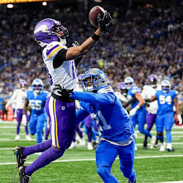 Minnesota Vikings wide receiver Justin Jefferson (18) makes a catch for a touchdown against Detroit Lions cornerback Amik Robertson (21) during the first half at Ford Field in Detroit on Sunday, November 2, 2025.