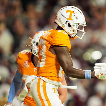 Nov 9, 2024; Knoxville, Tennessee, USA; Tennessee Volunteers defensive back Boo Carter (23) and defensive lineman Jaxson Moi (51) celebrate after a play against the Mississippi State Bulldogs during the first half at Neyland Stadium. Mandatory Credit: Caitie McMekin/USA TODAY Network via Imagn Images
