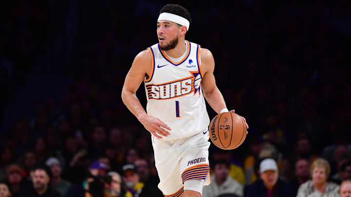 Jan 11, 2024; Los Angeles, California, USA; Phoenix Suns guard Devin Booker (1) moves the ball up court against the Los Angeles Lakers during the first half at Crypto.com Arena. Mandatory Credit: Gary A. Vasquez-Imagn Images