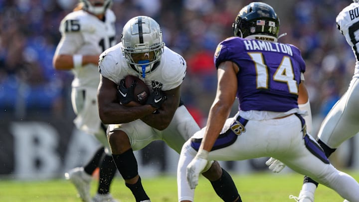 Sep 15, 2024; Baltimore, Maryland, USA; Las Vegas Raiders running back Zamir White (3) runs the ball as Baltimore Ravens safety Kyle Hamilton (14) defends during the second half at M&T Bank Stadium. Mandatory Credit: Reggie Hildred-Imagn Images