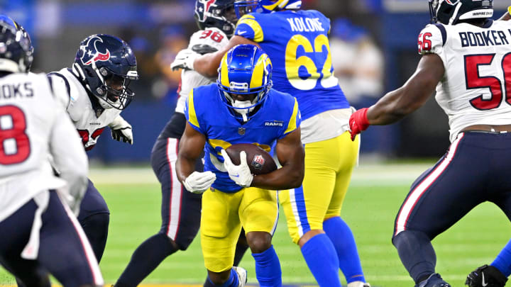 Aug 19, 2022; Inglewood, California, USA;   Los Angeles Rams running back Raymond Calais (30) carries the ball as he is stopped by Houston Texans defensive tackle Thomas Booker IV (56) in the first half at SoFi Stadium. Mandatory Credit: Jayne Kamin-Oncea-USA TODAY Sports