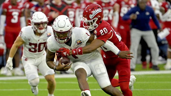 Dec 17, 2022; Inglewood, CA, USA;   Washington State Cougars quarterback Cameron Ward (1) is sacked by Fresno State Bulldogs defensive back Cam Lockridge (20) in the second half of the LA Bowl at SoFi Stadium. Mandatory Credit: Jayne Kamin-Oncea-USA TODAY Sports