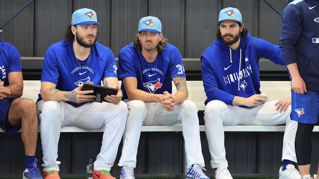 Feb 11, 2026; Dunedin, FL, USA;  Toronto Blue Jays pitcher Kevin Gausman (34), pitcher Dylan Cease (84),  pitcher Cody Ponce (37) watch the bullpen pitchers for spring training practice at Blue Jays Player Development Complex. Mandatory Credit: Kim Klement Neitzel-Imagn Images