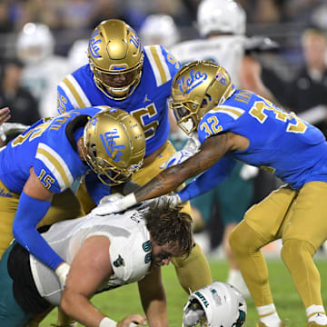 Sep 2, 2023; Pasadena, California, USA;    Coastal Carolina Chanticleers offensive lineman Will McDonald (66) loses his helmet as he is stopped by the UCLA Bruins offense after an interception in the second half at Rose Bowl. Mandatory Credit: Jayne Kamin-Oncea-Imagn Images