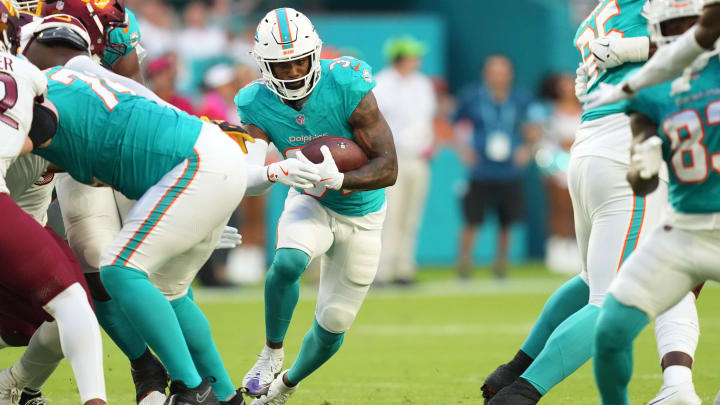 Miami Dolphins running back Raheem Mostert (31) runs for a first down against the Washington Commanders during the first quarter at Hard Rock Stadium.