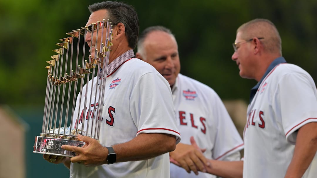 Jun 22, 2022; Anaheim, California, USA;  Former Los Angeles Angels Tim Salmon holds the 2002 World Series trophy during a pregame ceremony celebrating the 20th anniversary of the World Series title at Angel Stadium. Mandatory Credit: Jayne Kamin-Oncea-Imagn Images