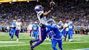 Minnesota Vikings wide receiver Justin Jefferson (18) makes a catch for a touchdown against Detroit Lions cornerback Amik Robertson (21) during the first half at Ford Field in Detroit on Sunday, November 2, 2025.