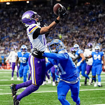 Minnesota Vikings wide receiver Justin Jefferson (18) makes a catch for a touchdown against Detroit Lions cornerback Amik Robertson (21) during the first half at Ford Field in Detroit on Sunday, November 2, 2025.