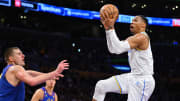 Oct 30, 2022; Los Angeles, California, USA;  Los Angeles Lakers guard Russell Westbrook (0) is defended by Denver Nuggets center Nikola Jokic (15) as he drives to the basket in the second half at Crypto.com Arena. 