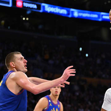 Oct 30, 2022; Los Angeles, California, USA;  Los Angeles Lakers guard Russell Westbrook (0) is defended by Denver Nuggets center Nikola Jokic (15) as he drives to the basket in the second half at Crypto.com Arena. 