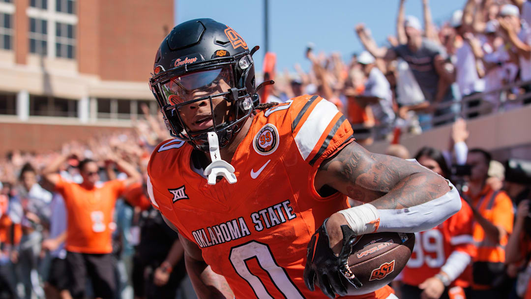 Sep 7, 2024; Stillwater, Oklahoma, USA; Oklahoma State Cowboys running back Ollie Gordon II (0) scores a touchdown in the second overtime against the Arkansas Razorbacks at Boone Pickens Stadium. Mandatory Credit: William Purnell-Imagn Images