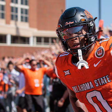 Sep 7, 2024; Stillwater, Oklahoma, USA; Oklahoma State Cowboys running back Ollie Gordon II (0) scores a touchdown in the second overtime against the Arkansas Razorbacks at Boone Pickens Stadium. Mandatory Credit: William Purnell-Imagn Images