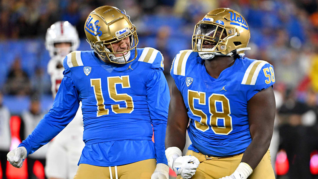 Oct 29, 2022; Pasadena, California, USA;  UCLA Bruins linebacker Laiatu Latu (15) and defensive lineman Gary Smith III (58) celebrate after a sack of Stanford Cardinal quarterback Tanner McKee (18)  in the first half at the Rose Bowl. Mandatory Credit: Jayne Kamin-Oncea-Imagn Images