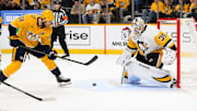 Dec 19, 2024; Nashville, Tennessee, USA;  Pittsburg Penguins goaltender Tristan Jarry (35) blocks the shot of Nashville Predators center Ryan O'Reilly (90) during the first period at Bridgestone Arena. Mandatory Credit: Steve Roberts-Imagn Images