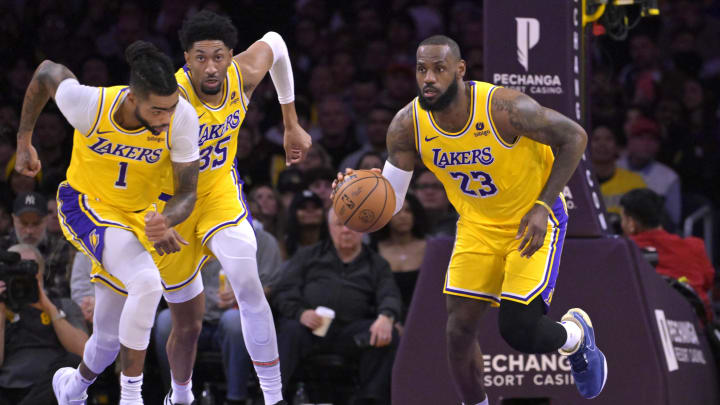 Dec 28, 2023; Los Angeles, California, USA;  Los Angeles Lakers guard D'Angelo Russell (1) and forward Christian Wood (35) trail as forward LeBron James (23) takes the ball down court in the first half against the Charlotte Hornets at Crypto.com Arena. Mandatory Credit: Jayne Kamin-Oncea-USA TODAY Sports