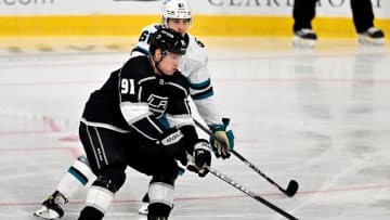 Sep 28, 2022; Ontario, California, USA;  Los Angeles Kings right wing Carl Grundstrom (91) and San Jose Sharks defenseman Santeri Hatakka (61) battle for the puck during a preseason at Toyota Arena. Mandatory Credit: Jayne Kamin-Oncea-USA TODAY Sports