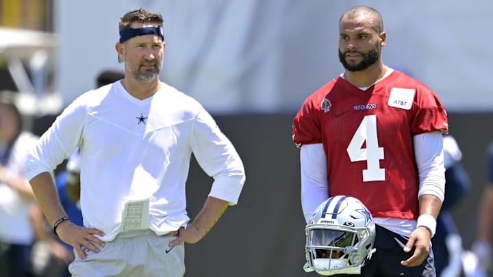 Dallas Cowboys quarterback Dak Prescott talks with offensive coordinator Brian Schottenheimer during training camp at River Ridge Playing Fields in Oxnard, CA.
