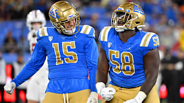Oct 29, 2022; Pasadena, California, USA;  UCLA Bruins linebacker Laiatu Latu (15) and defensive lineman Gary Smith III (58) celebrate after a sack of Stanford Cardinal quarterback Tanner McKee (18)  in the first half at the Rose Bowl. Mandatory Credit: Jayne Kamin-Oncea-Imagn Images
