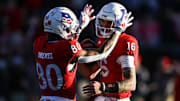 Rutgers Scarlet Knights quarterback Athan Kaliakmanis (16) celebrates with running back Jordan Smikle (80)