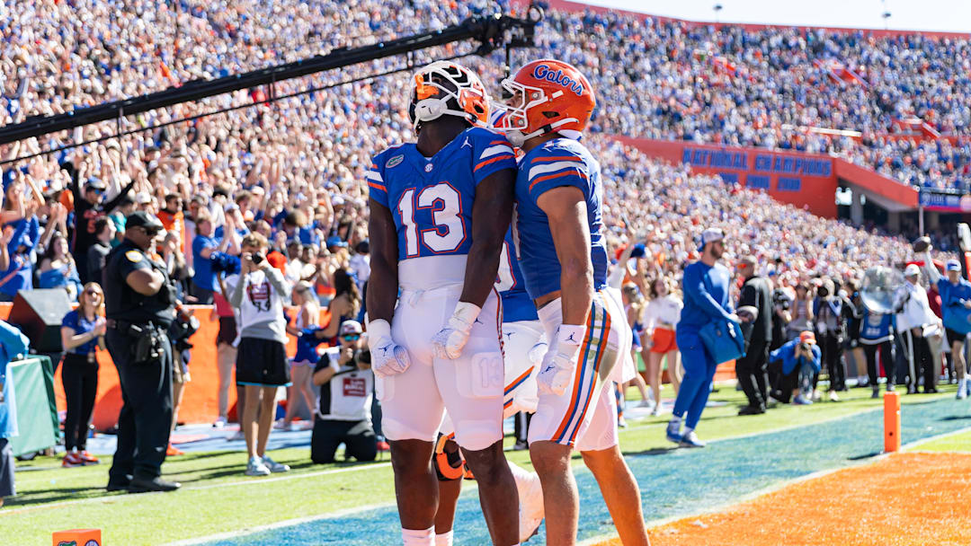 Nov 23, 2024; Gainesville, Florida, USA; Florida Gators running back Jadan Baugh (13) celebrates scoring a touchdown with Florida Gators wide receiver Chimere Dike (17) against the Mississippi Rebels during the first half at Ben Hill Griffin Stadium. Mandatory Credit: Matt Pendleton-Imagn Images