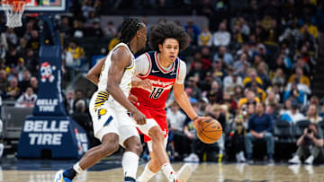 Apr 8, 2025; Indianapolis, Indiana, USA; Washington Wizards forward Kyshawn George (18) dribbles the ball while Indiana Pacers forward Aaron Nesmith (23) defends in the second half at Gainbridge Fieldhouse. Mandatory Credit: Trevor Ruszkowski-Imagn Images