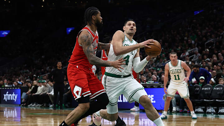 Feb 11, 2026; Boston, Massachusetts, USA; Boston Celtics center Nikola Vucevic (4) drives on Chicago Bulls center Nick Richards (13) during the first quarter at TD Garden. Mandatory Credit: Winslow Townson-Imagn Images