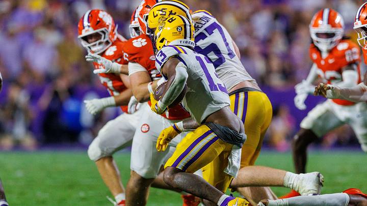 Sep 5, 2026; Baton Rouge, Louisiana, USA;  LSU Tigers running back Dilin Jones (13) eludes a tackle against Clemson Tigers during the first half at Tiger Stadium.  Mandatory Credit: Stephen Lew-Imagn Images