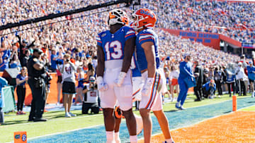 Nov 23, 2024; Gainesville, Florida, USA; Florida Gators running back Jadan Baugh (13) celebrates scoring a touchdown with Florida Gators wide receiver Chimere Dike (17) against the Mississippi Rebels during the first half at Ben Hill Griffin Stadium. Mandatory Credit: Matt Pendleton-Imagn Images