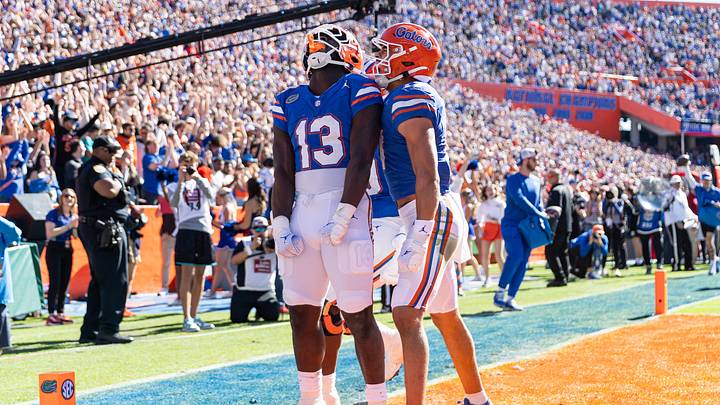 Nov 23, 2024; Gainesville, Florida, USA; Florida Gators running back Jadan Baugh (13) celebrates scoring a touchdown with Florida Gators wide receiver Chimere Dike (17) against the Mississippi Rebels during the first half at Ben Hill Griffin Stadium. Mandatory Credit: Matt Pendleton-Imagn Images