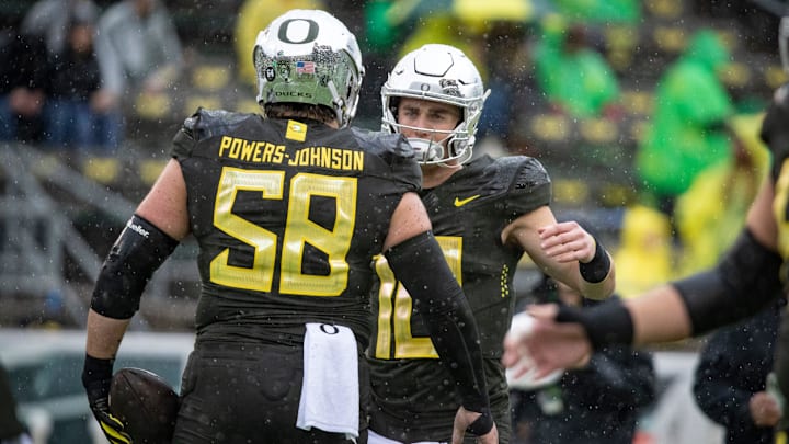 Oregon quarterback Bo Nix greets offensive lineman Jackson Powers-Johnson as the No. 6 Oregon Ducks host California Saturday, Nov. 4, 2023, at Autzen Stadium in Eugene, Ore.