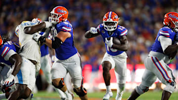 Aug 30, 2025; Gainesville, Florida, USA; Florida Gators running back Jadan Baugh (13) runs with the ball while Florida Gators offensive lineman Jake Slaughter (66) blocks against the Long Island Sharks during the first half at Ben Hill Griffin Stadium. Mandatory Credit: Matt Pendleton-Imagn Images