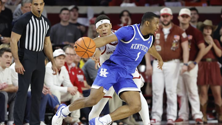 Feb 26, 2025; Norman, Oklahoma, USA; Kentucky Wildcats guard Lamont Butler (1) moves around Oklahoma Sooners guard Jeremiah Fears (0) on a drive during the second half at Lloyd Noble Center. Mandatory Credit: Alonzo Adams-Imagn Images