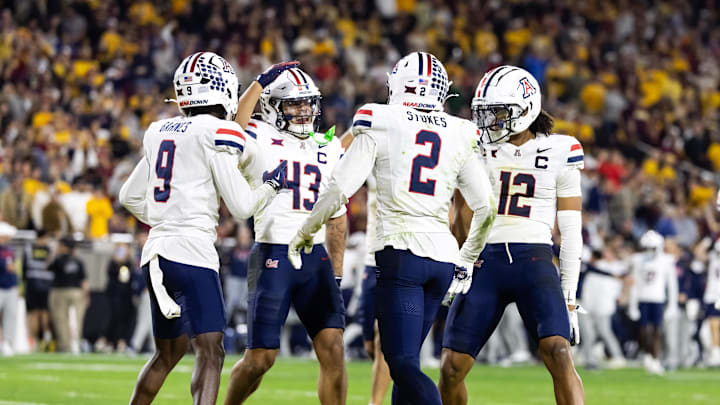 Nov 28, 2025; Tempe, Arizona, USA; Arizona Wildcats defensive back Treydan Stukes (2) celebrates with Ayden Garnes (9), Dalton Johnson (43) and Genesis Smith (12) after an interception against Arizona State Sun Devils in the second half during the 99th Territorial Cup at Mountain America Stadium. Mandatory Credit: Mark J. Rebilas-Imagn Images