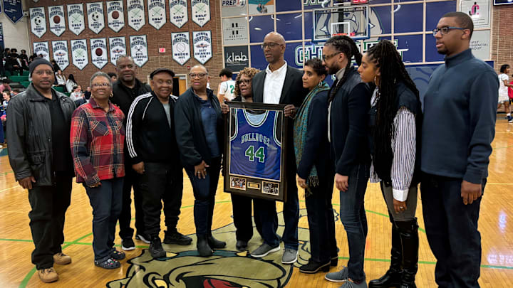 Surrounded by family and friends, as well as his high school coach and teammates, Eric Smith holds up his framed No. 44 Winston Churchill high school jersey, which was retired on Friday night at the Maryland school. Surrounded by family and friends, as well as his high school coach and teammates, Eric Smith holds up his framed No. 44 Winston Churchill high school jersey, which was retired on Friday night at the Maryland school.
