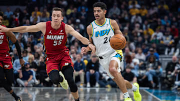 Nov 17, 2024; Indianapolis, Indiana, USA; Indiana Pacers guard Ben Sheppard (26) dribbles the ball while Miami Heat forward Duncan Robinson (55) defends in the first half at Gainbridge Fieldhouse. Mandatory Credit: Trevor Ruszkowski-Imagn Images