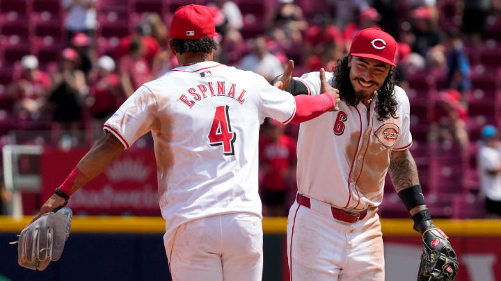 Cincinnati Reds first base Santiago Espinal (4) and second base Jonathan India (6) celebrate a win after the ninth inning of the MLB National League game between the Cincinnati Reds and the Colorado Rockies at Great American Ball Park in downtown Cincinnati on Thursday, July 11, 2024. The Reds led 3-0 after three innings. The Reds won 8-1.