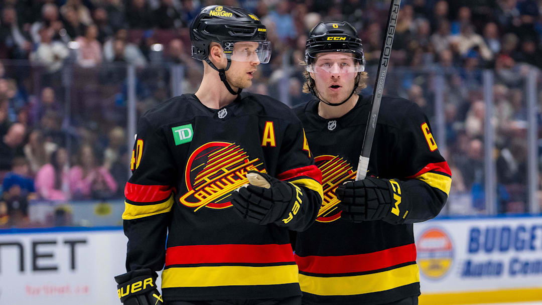 Jan 21, 2025; Vancouver, British Columbia, CAN; Vancouver Canucks forward Elias Pettersson (40) talks with forward Brock Boeser (6) against the Buffalo Sabres in the second period at Rogers Arena. Mandatory Credit: Bob Frid-Imagn Images