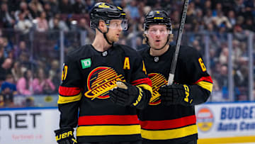 Jan 21, 2025; Vancouver, British Columbia, CAN; Vancouver Canucks forward Elias Pettersson (40) talks with forward Brock Boeser (6) against the Buffalo Sabres in the second period at Rogers Arena. Mandatory Credit: Bob Frid-Imagn Images