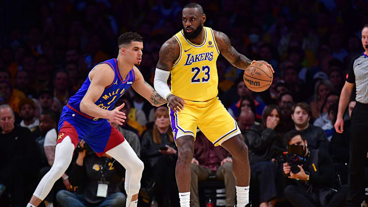 Apr 25, 2024; Los Angeles, California, USA; Los Angeles Lakers forward LeBron James (23) controls the ball against Denver Nuggets forward Michael Porter Jr. (1) during the first half in game three of the first round for the 2024 NBA playoffs at Crypto.com Arena. Mandatory Credit: Gary A. Vasquez-Imagn Images