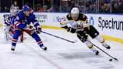 Feb 5, 2025; New York, New York, USA; Boston Bruins left wing Brad Marchand (63) controls the puck against New York Rangers defenseman Ryan Lindgren (55) during the first period at Madison Square Garden. Mandatory Credit: Brad Penner-Imagn Images