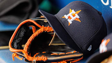 Apr 27, 2025; Kansas City, Missouri, USA; Houston Astros hat and glove in the dugout during the second inning against the Kansas City Royals at Kauffman Stadium. 
