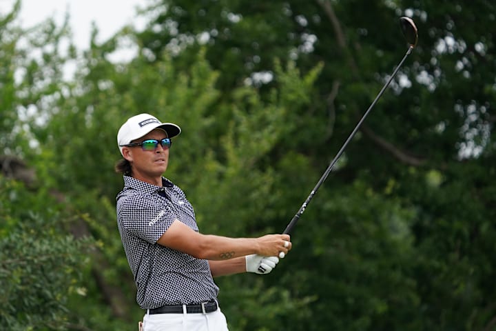 Rickie Fowler watches his shot from the ninth tee during the third round of the Charles Schwab Challenge golf tournament. 